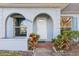 Front door entrance with arched entryway and brick walkway at 4009 38Th Avenue W Dr # 4009, Bradenton, FL 34205