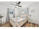 This sunny bedroom offers a queen bed with marine themed bedding and wood-look flooring at 151 Adair Ave, Sarasota, FL 34243