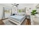 Bright bedroom with a white frame bed, ceiling fan, and two windows creating a relaxing atmosphere at 151 Adair Ave, Sarasota, FL 34243