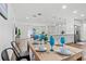 Light and airy dining area with wood table and blue glasses at 151 Adair Ave, Sarasota, FL 34243