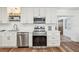 Clean kitchen featuring stainless steel appliances, subway tile backsplash, sleek countertops, and ample cabinetry at 151 Adair Ave, Sarasota, FL 34243