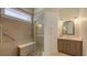 Spa-like bathroom with a walk-in shower, built-in shelving, and a modern vanity at 1775 Stapleton St, Sarasota, FL 34239