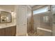 Bathroom with walk-in shower, pebble floor, and modern vanity with sink at 1775 Stapleton St, Sarasota, FL 34239