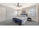 Spacious bedroom with a queen-size bed, two nightstands, and a bench at the foot of the bed at 1775 Stapleton St, Sarasota, FL 34239