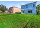 Large backyard with two houses and green lawn at 206 Beacon Harbour Loop, Bradenton, FL 34212