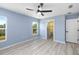 Bright bedroom with light gray walls and wood-look flooring at 206 Beacon Harbour Loop, Bradenton, FL 34212