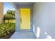 Inviting yellow front door entrance with landscaping at 206 Beacon Harbour Loop, Bradenton, FL 34212