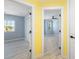 Bright hallway with yellow walls and access to bedrooms at 206 Beacon Harbour Loop, Bradenton, FL 34212