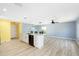 Open concept kitchen with white cabinets and island at 206 Beacon Harbour Loop, Bradenton, FL 34212