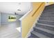 Modern staircase with gray carpeting and yellow wall at 206 Beacon Harbour Loop, Bradenton, FL 34212