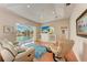 Living room with comfy seating, large TV, and sliding doors to the pool area at 3522 Little Country Rd, Parrish, FL 34219