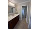 Updated bathroom with dark brown vanity and a walk-in shower at 4409 Eleuthera Ct, Sarasota, FL 34233