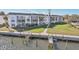 Aerial view of condo building, walkway, and private boat dock at 4440 Exeter Dr # N304, Longboat Key, FL 34228