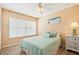 Bright bedroom with a queen bed, light teal bedding, and a large window at 4440 Exeter Dr # N304, Longboat Key, FL 34228