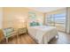 Bright bedroom with water views and a comfortable bed at 4440 Exeter Dr # N304, Longboat Key, FL 34228