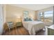 Bedroom with water views and light wood floors at 4440 Exeter Dr # N304, Longboat Key, FL 34228