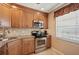 Kitchen with stainless steel appliances and wood cabinets at 4440 Exeter Dr # N304, Longboat Key, FL 34228