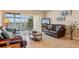 Living room with leather sofas, water views and balcony access at 4440 Exeter Dr # N304, Longboat Key, FL 34228