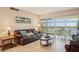 Bright living room, leather sofas, water views, balcony access at 4440 Exeter Dr # N304, Longboat Key, FL 34228