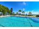 Inviting community pool with lounge chairs and waterfront views at 4440 Exeter Dr # N304, Longboat Key, FL 34228