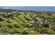 Aerial view of lush golf course with ponds and residential area at 4557 Bay Club Dr, Bradenton, FL 34210