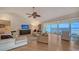 Bright living room with hardwood floors, water views, and comfortable seating at 4557 Bay Club Dr, Bradenton, FL 34210