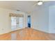 Living room with wood floors and French doors leading to a sunroom at 5604 Garden Lakes Dr, Bradenton, FL 34203