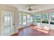 Sunroom with tile floors, ceiling fan, and garden views at 5604 Garden Lakes Dr, Bradenton, FL 34203