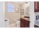 Powder room with dark wood vanity and granite countertop at 6503 Moorings Point Cir # 202, Lakewood Ranch, FL 34202