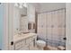 Clean bathroom with a shower/tub combo and coastal decor at 6503 Moorings Point Cir # 202, Lakewood Ranch, FL 34202