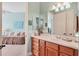 Bathroom with a double vanity and a view into a bedroom at 6503 Moorings Point Cir # 202, Lakewood Ranch, FL 34202