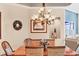 Bright dining room featuring a wooden table and chandelier at 6503 Moorings Point Cir # 202, Lakewood Ranch, FL 34202