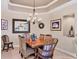 Charming dining room with a wood table and wicker chairs at 6503 Moorings Point Cir # 202, Lakewood Ranch, FL 34202