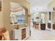 View into kitchen from entryway, showing island and breakfast bar at 6503 Moorings Point Cir # 202, Lakewood Ranch, FL 34202