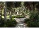 Landscaped walkway through lush tropical foliage at 6503 Moorings Point Cir # 202, Lakewood Ranch, FL 34202