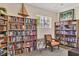 Well-lit library with numerous bookshelves and comfortable seating at 6503 Moorings Point Cir # 202, Lakewood Ranch, FL 34202