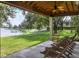 Covered patio overlooking a lake with comfortable seating at 6503 Moorings Point Cir # 202, Lakewood Ranch, FL 34202