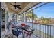 Spacious screened balcony with lake views and patio furniture at 6503 Moorings Point Cir # 202, Lakewood Ranch, FL 34202