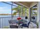 Enjoy lake views from this screened balcony with patio table at 6503 Moorings Point Cir # 202, Lakewood Ranch, FL 34202