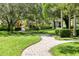 Paved walkway winding through a lush, landscaped area at 6503 Moorings Point Cir # 202, Lakewood Ranch, FL 34202