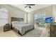 Spacious bedroom with wood-like platform bed, and sliding doors to the pool at 8186 Shadow Pine Way, Sarasota, FL 34238