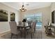 Bright dining room with table and chairs, pool view at 8186 Shadow Pine Way, Sarasota, FL 34238