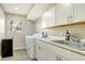 Laundry room with washer, dryer, and utility sink at 8186 Shadow Pine Way, Sarasota, FL 34238