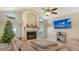 Cozy living room with fireplace and large TV at 8186 Shadow Pine Way, Sarasota, FL 34238