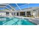 Inviting pool area with covered patio and seating at 8186 Shadow Pine Way, Sarasota, FL 34238