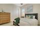 Guest bedroom with wood dresser and neutral tones at 16026 39Th E Gln, Parrish, FL 34219