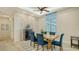 Modern dining area with blue chairs and stone accent wall at 16026 39Th E Gln, Parrish, FL 34219