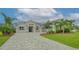 Single-story home with gray exterior, stone accents, and a three-car garage at 16026 39Th E Gln, Parrish, FL 34219