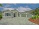 Single-story home with gray exterior, stone accents, and a three-car garage at 16026 39Th E Gln, Parrish, FL 34219