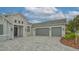 Two-car garage, stone accents, and a paved driveway enhance this home's exterior at 16026 39Th E Gln, Parrish, FL 34219